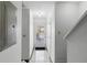 Bright hallway with tiled flooring leading to the front door and staircase at 564 Shadow Glenn Pl, Winter Springs, FL 32708