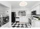 Open kitchen layout with adjacent laundry area, blending convenience and functionality at 564 Shadow Glenn Pl, Winter Springs, FL 32708