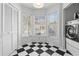 Laundry area with bright bay window and washer/dryer hookups on stylish tile floor at 564 Shadow Glenn Pl, Winter Springs, FL 32708