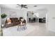 Open-concept living and dining area with sleek tile flooring and a modern ceiling fan at 564 Shadow Glenn Pl, Winter Springs, FL 32708