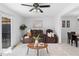 Open-concept living and dining area with sleek tile flooring, a modern ceiling fan, and backyard access at 564 Shadow Glenn Pl, Winter Springs, FL 32708