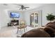 Comfortable living room featuring a ceiling fan, fireplace, a brown leather sofa, and access to the backyard at 564 Shadow Glenn Pl, Winter Springs, FL 32708