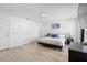 Bright main bedroom with sleek wood-look tile flooring, neutral paint, and a large window at 564 Shadow Glenn Pl, Winter Springs, FL 32708