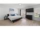 This cozy main bedroom has sleek wood-look tile flooring and a large window at 564 Shadow Glenn Pl, Winter Springs, FL 32708