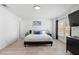Spacious main bedroom with a bed, light wood floor, and natural light from the window at 564 Shadow Glenn Pl, Winter Springs, FL 32708