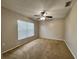 Spacious bedroom with ceiling fan and large window at 594 Terranova Cir, Winter Haven, FL 33884