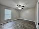 Spacious bedroom with wood-look flooring and ceiling fan at 594 Terranova Cir, Winter Haven, FL 33884