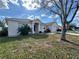 Exterior view of house with mature tree and landscaping at 594 Terranova Cir, Winter Haven, FL 33884