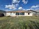 Back of house, showcasing a large backyard and a wooden deck at 594 Terranova Cir, Winter Haven, FL 33884