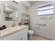 Bright bathroom with a modern vanity, storage shelving, and accessibility features for added convenience at 616 Mellowood Ave, Orlando, FL 32825