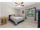 Cozy bedroom with tile flooring, a comfortable bed, and natural light from the window at 616 Mellowood Ave, Orlando, FL 32825