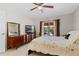 Sunlit bedroom with tile flooring, mid-century modern furniture, and a view of the outdoor patio at 616 Mellowood Ave, Orlando, FL 32825