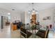 Bright dining room with modern light fixture, tile flooring, and adjacent rooms at 616 Mellowood Ave, Orlando, FL 32825