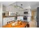 Well-lit kitchen featuring white cabinets, stainless steel appliances, and an adjacent dining area with natural lighting at 616 Mellowood Ave, Orlando, FL 32825