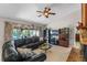 Bright living room with tile floors, modern ceiling fan, sectional couch, and large sliding glass doors at 616 Mellowood Ave, Orlando, FL 32825