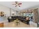 Relaxing living room with tile floors, modern ceiling fan, sectional couch, and sliding glass doors to patio at 616 Mellowood Ave, Orlando, FL 32825