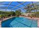 Inviting screened-in pool with lush landscaping under a clear blue sky at 616 Mellowood Ave, Orlando, FL 32825