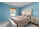 Bright bedroom with blue walls and white bed frame with bedside tables and white tile flooring at 741 Gila Dr, Kissimmee, FL 34759