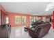 Relaxing living room with leather furniture, tile flooring, and natural light from sliding glass doors at 741 Gila Dr, Kissimmee, FL 34759