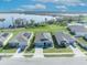 Aerial view of three houses on a street near a lake and conservation area showing solar panels on roofs at 812 Gisele Ct, Haines City, FL 33844