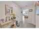 Neutral entryway with console table, decor and view of dining and living spaces at 812 Gisele Ct, Haines City, FL 33844