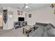 Comfortable living room features carpet, neutral walls, a gray sectional, and a television at 812 Gisele Ct, Haines City, FL 33844