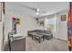 Cozy living room features carpet, neutral walls, a ceiling fan, and a window with bright natural light at 812 Gisele Ct, Haines City, FL 33844