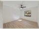 Bright bedroom with wood-look floors and large window at 8546 Amber Oak Dr, Orlando, FL 32817