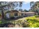 Side view of house showcasing stone facade and lush landscaping at 8546 Amber Oak Dr, Orlando, FL 32817