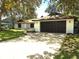 Charming single-story home with a well-maintained lawn and a two-car garage at 8546 Amber Oak Dr, Orlando, FL 32817