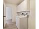 Laundry room with washer, dryer, and upper cabinets at 8546 Amber Oak Dr, Orlando, FL 32817