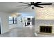 Open living area featuring a stone fireplace and a modern kitchen in the background at 8546 Amber Oak Dr, Orlando, FL 32817