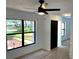 Bright living room featuring large windows, ceiling fan, and new flooring at 8546 Amber Oak Dr, Orlando, FL 32817