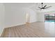 Open living room featuring wood-look floors and sliding glass doors to the pool at 8546 Amber Oak Dr, Orlando, FL 32817