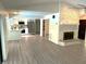 Spacious living area with modern fireplace, new flooring, and an open layout to the kitchen at 8546 Amber Oak Dr, Orlando, FL 32817