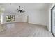 Spacious living room featuring wood-look flooring, a fireplace, and a ceiling fan at 8546 Amber Oak Dr, Orlando, FL 32817