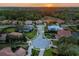 Panoramic aerial view of a luxury community boasting well-manicured lawns, and mature trees as the sun sets at 8585 Cypress Ridge Ct, Sanford, FL 32771