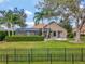 The well-manicured backyard features a screened porch, lush lawn, privacy hedges, and a cozy fire pit, offering a private outdoor retreat at 8585 Cypress Ridge Ct, Sanford, FL 32771