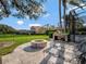 Features a built-in pizza oven, stone fire pit, lounge chairs, and a lush green lawn, ideal for outdoor gatherings at 8585 Cypress Ridge Ct, Sanford, FL 32771