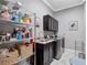 Well-organized laundry room with modern washer and dryer, sink, and ample storage space at 8585 Cypress Ridge Ct, Sanford, FL 32771