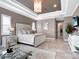 Well-lit main bedroom featuring a seating area with a glass coffee table and a view into the en-suite bathroom at 8585 Cypress Ridge Ct, Sanford, FL 32771