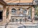 Outdoor kitchen featuring a stone bar, stainless steel grill, and seating area, adjacent to the pool at 8585 Cypress Ridge Ct, Sanford, FL 32771