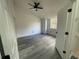 A bedroom featuring hardwood floors, a window, and a fan at 948 Bird Bay Ct # 206, Lake Mary, FL 32746