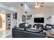 Open living room with black leather couches and a wood accent wall at 970 E Michigan St # B, Orlando, FL 32806