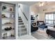 Living room with stairs, gray shelves, and a baby gate at 970 E Michigan St # B, Orlando, FL 32806