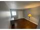 Bedroom featuring hardwood floors, closet and a window for natural light at 116 Scottsdale Sq # 2, Winter Park, FL 32792