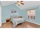 Bedroom features a bed, windows, and blue colored walls at 1220 Villa Ln # 135, Apopka, FL 32712