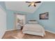 Bedroom with wood floors, a cozy bed, and a window offering natural light at 1220 Villa Ln # 135, Apopka, FL 32712