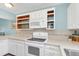 Bright kitchen featuring white cabinets, tile countertops, and a modern electric range at 1220 Villa Ln # 135, Apopka, FL 32712