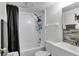 Bright bathroom with a shower-tub combo, white subway tile, and modern fixtures at 134 Springwood Cir # A, Longwood, FL 32750